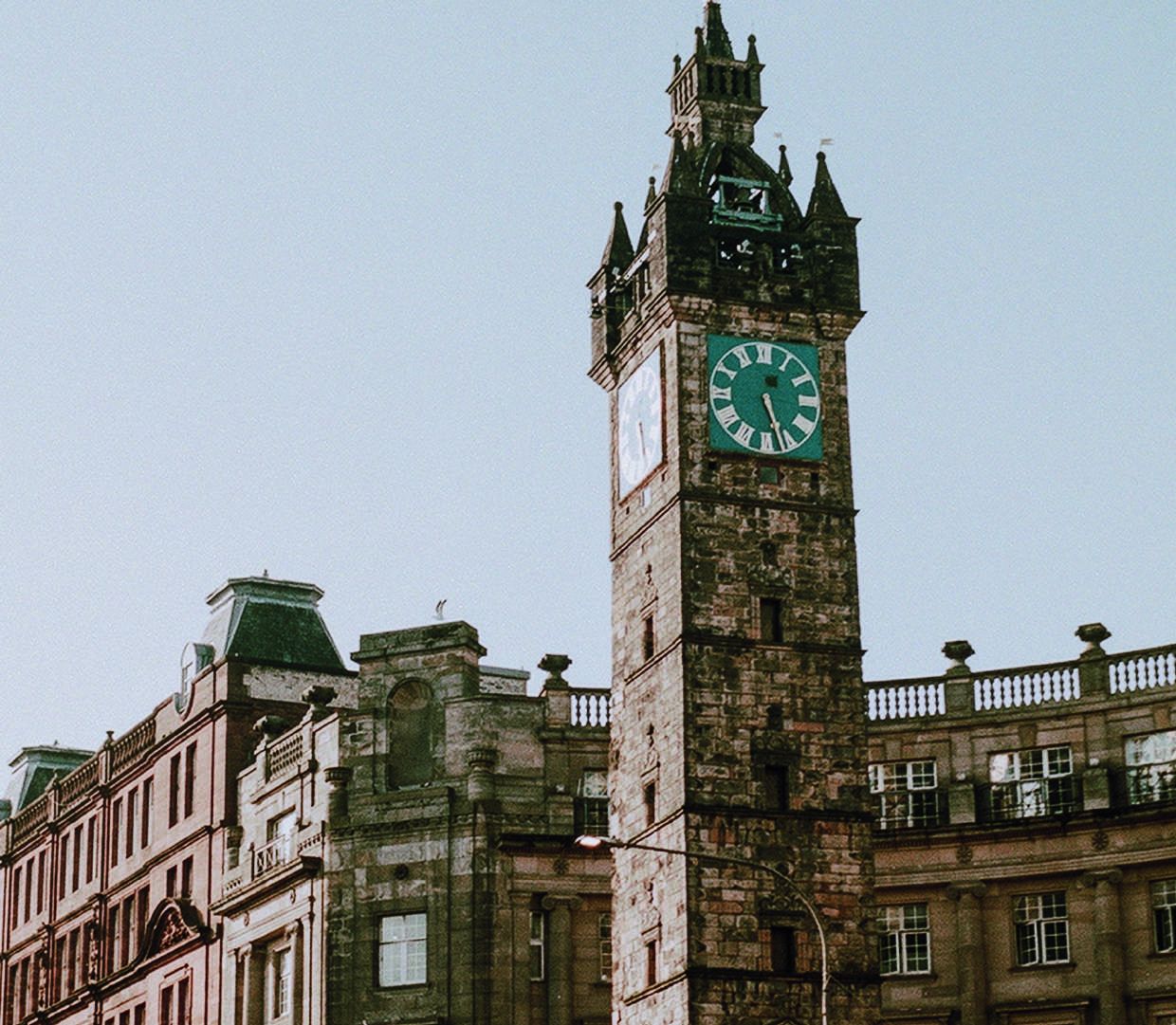 The Tolbooth Steeple's clock tower rising over Glasgow's Merchant City facades